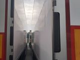 two trucks that are parked side by side in the street