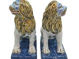 pair of ceramic lion bookends with blue base and gold mane
