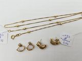 a collection of gold necklaces and earrings