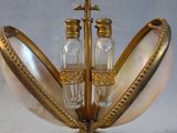 a gold plate with salt and pepper shakers in it