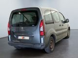 a small grey van parked in a large room