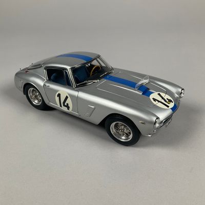 a silver car with a number on the side of it