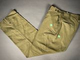 khaki pants with a green label on the side of the pants