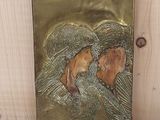 une photo d'une plaque métallique sur laquelle figurent les portraits d'un homme et d'une femme