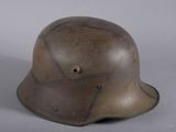 an old helmet with holes on the side of it sitting on a table