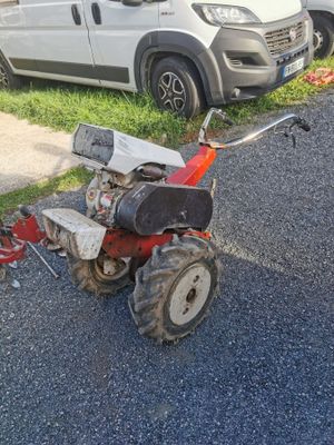 a small tractor that is parked on the side of the road
