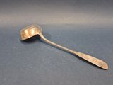 silver spoon with a spoon handle on a blue surface