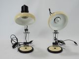 pair of yellow and white lamps with black bases on a white background