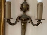 a picture of a wall mounted light with two candles on it