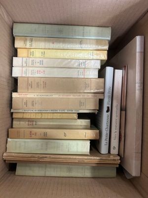 a box full of books that are stacked on top of each other
