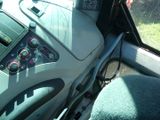 a view of the dashboard of a bus from the driver ' s seat