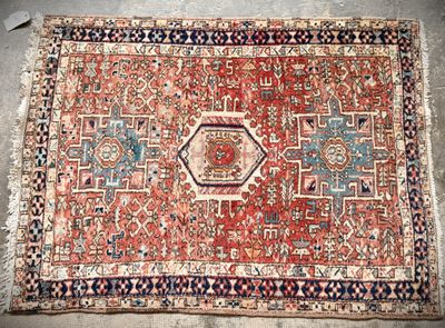an old persian rug with a red and blue design on it