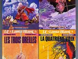 four books in french are on a table with a gray background