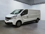 the white van is parked in the large room of the building