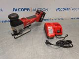 a red corded electric tool sitting on top of a table