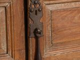 a close up of a door handle on a wooden door