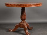 a round table with a wooden top and a wooden base
