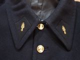 a black coat with gold buttons on it
