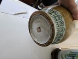 a person pouring something into a jar on a table