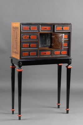 an image of a black and orange cabinet with drawers