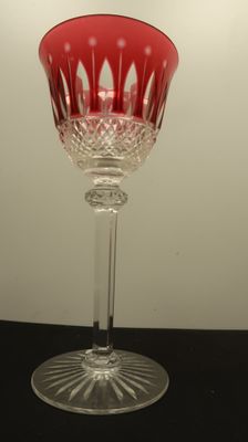 a red wine glass sitting on a black table