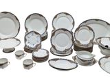 many different types of plates and bowls on this table