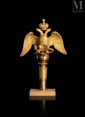 an image of a golden statue of a bird with a crown on it