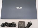 the asus laptop has a charger and power cord attached to it
