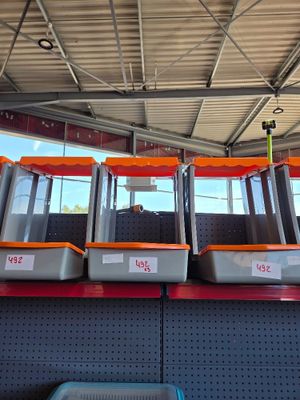 a row of orange and gray machines on display in a store