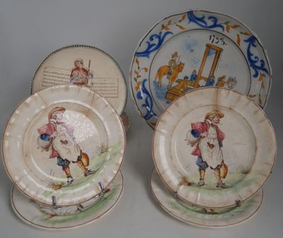 two plates with a picture of a boy and a dog on them