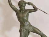 bronze statue of a man holding a spear on a marble base