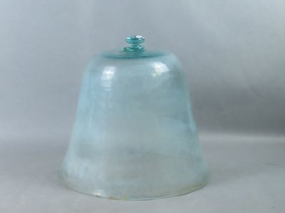une cloche en verre avec un couvercle bleu posée sur une surface blanche