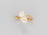 a yellow gold ring with two white diamonds