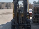 a forklift that is sitting in the middle of a parking lot