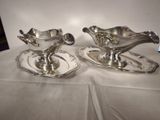 pair of silver plated saucers on trays on a table