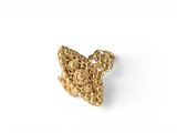 a close up of a piece of gold jewelry on a white surface