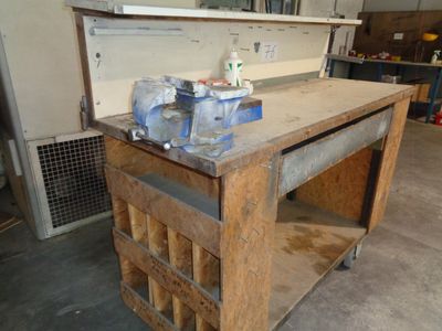 a workbench with tools on top of it in a garage