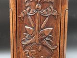 an old wooden cabinet with a carved design on the front