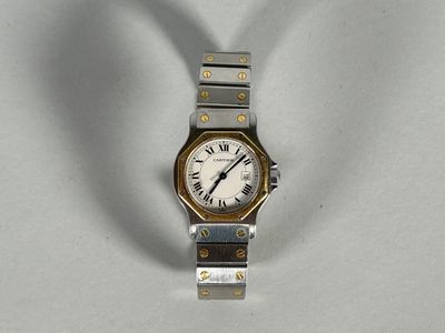 a silver and gold wrist watch with roman numerals on it