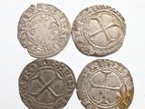 three silver coins with a cross on the front and a cross on the back