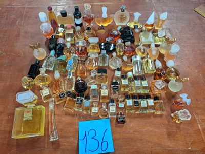 a lot of perfume bottles on a table with a price tag