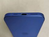 a close up of the back of a blue iphone with a camera attached