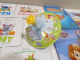 many children ' s books on a table with a cup and saucer