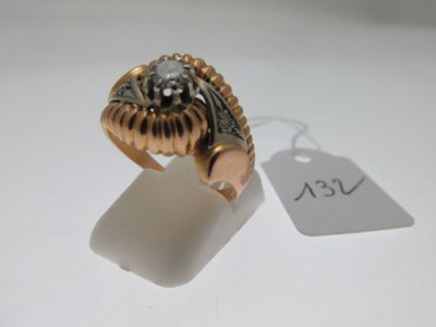 a gold ring with a skull on it and a price tag