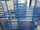 many blue cages that are in a room
