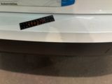 a sticker on the back of a car that has a remote control on it