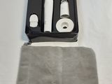 a black box with two brushes in it and a gray bag