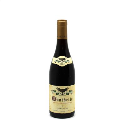 the bottle of wine is sitting on a white surface