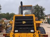 a large yellow construction vehicle parked in a parking lot