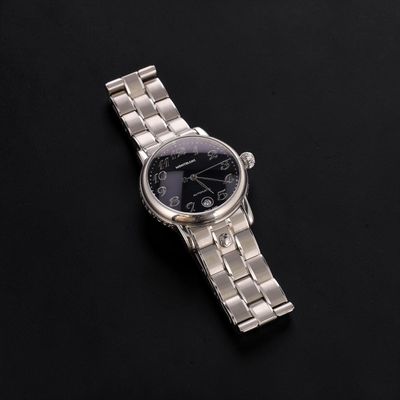 a close up of a watch on a black surface